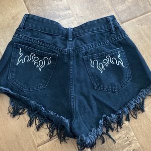 black jean shorts with flame embroidery pockets